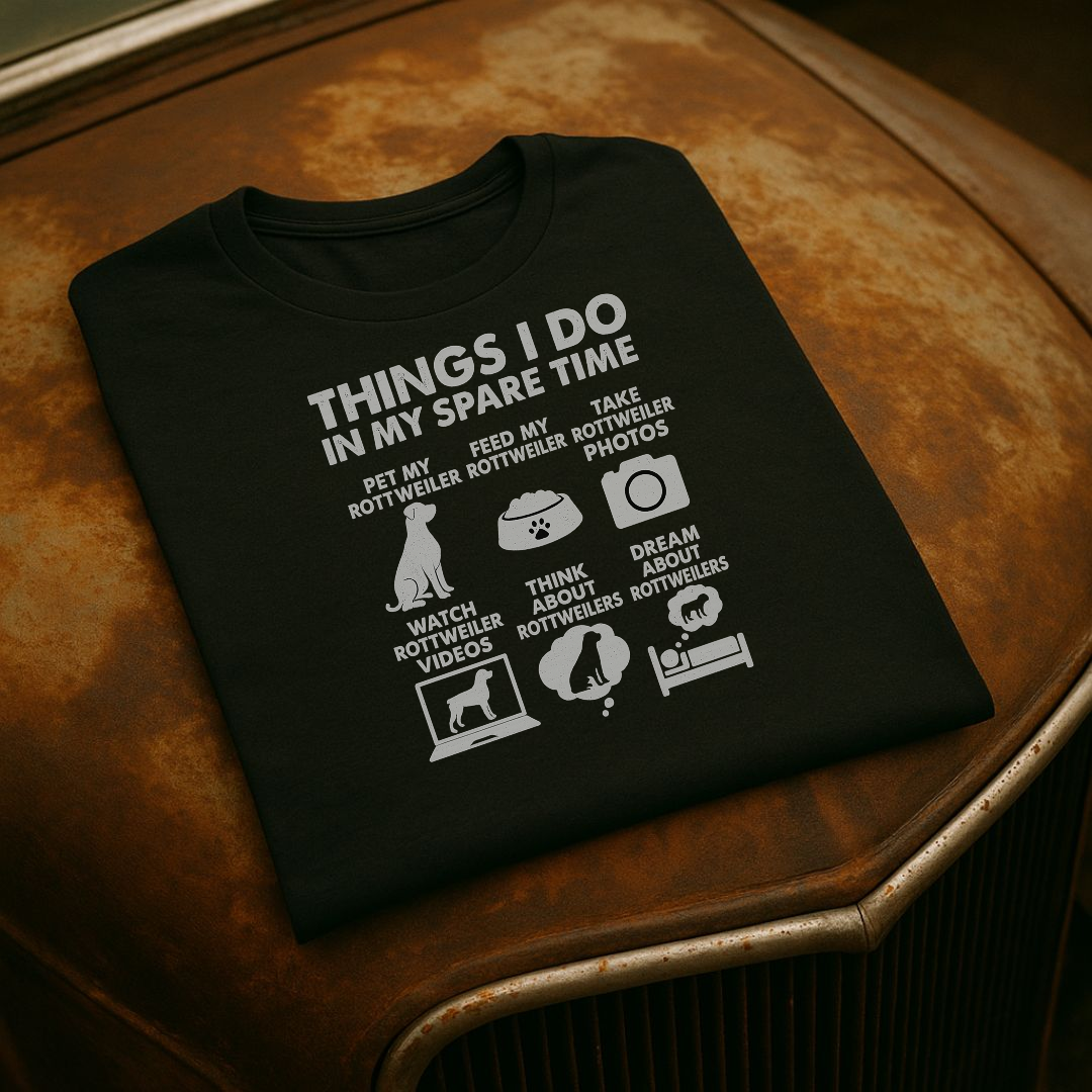 Black t-shirt with white text and graphics on a car hood