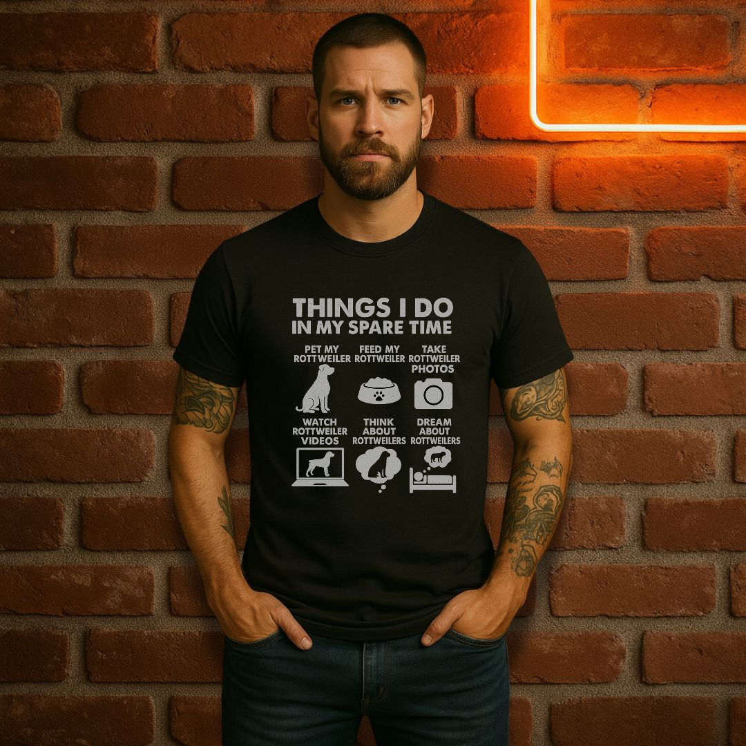 Man wearing a black t-shirt with text and graphics against a brick wall.