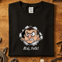 Æsj Folk T-Skjorte med et humoristisk design av en sint karakter mot en svart bakgrunn.
