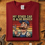 My Other Car Is Also Broken T-Skjorte med vintage verkstedmotiv på rød genser, perfekt for bilentusiasten.